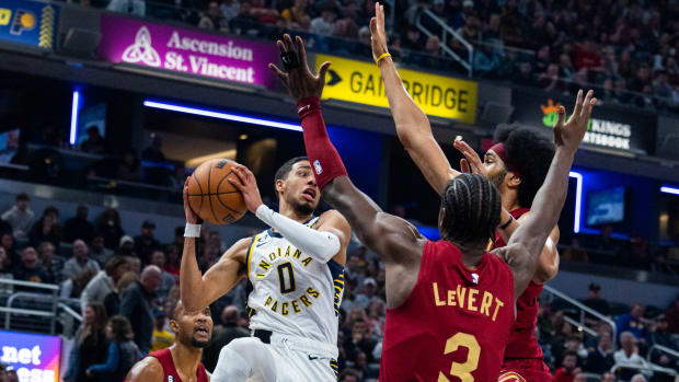 Dec 29, 2022; Indianapolis, Indiana, USA; Indiana Pacers guard Tyrese Haliburton (0) passes the ball while Cleveland Cavaliers guard Caris LeVert (3) defends at Gainbridge Fieldhouse. Mandatory Credit: Trevor Ruszkowski-USA TODAY Sports